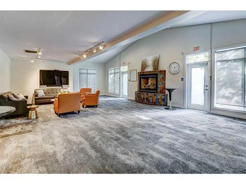 205-2 Hemlock Crescent Sw, Calgary, AB - Indoor Photo Showing Living Room With Fireplace