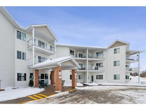 201-3 Parklane Way, Strathmore, AB - Outdoor With Balcony With Facade