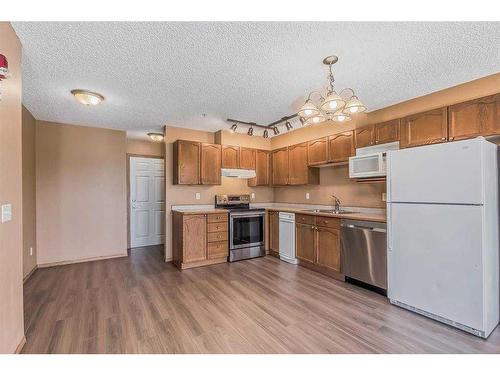 202-3 Somervale View Sw, Calgary, AB - Indoor Photo Showing Kitchen With Double Sink