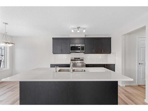 805 Windbury Street Sw, Airdrie, AB - Indoor Photo Showing Kitchen With Double Sink With Upgraded Kitchen