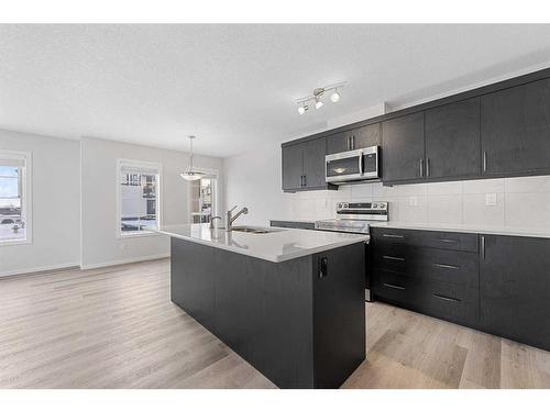 805 Windbury Street Sw, Airdrie, AB - Indoor Photo Showing Kitchen With Upgraded Kitchen