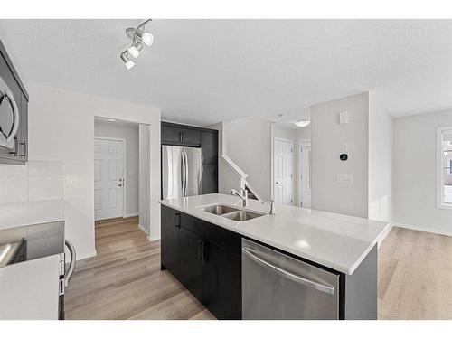 805 Windbury Street Sw, Airdrie, AB - Indoor Photo Showing Kitchen With Stainless Steel Kitchen With Double Sink