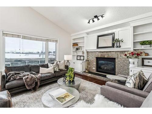 751 Mckenzie Lake Bay Se, Calgary, AB - Indoor Photo Showing Living Room With Fireplace