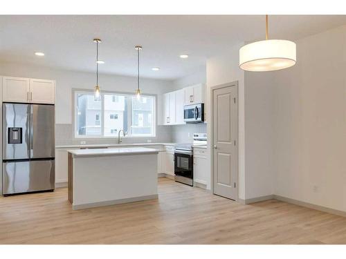 513 Bayview Street Sw, Airdrie, AB - Indoor Photo Showing Kitchen With Upgraded Kitchen