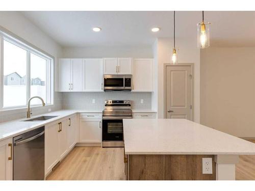 513 Bayview Street Sw, Airdrie, AB - Indoor Photo Showing Kitchen With Upgraded Kitchen