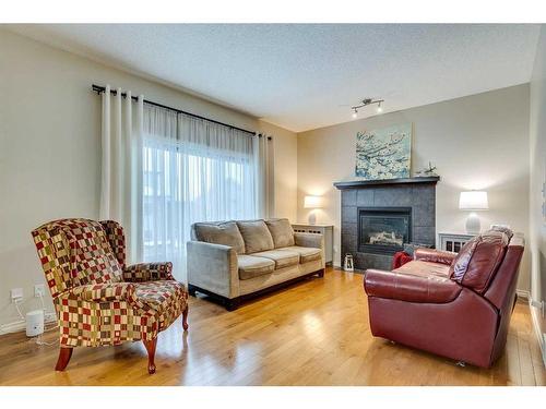 229 Cimarron Drive, Okotoks, AB - Indoor Photo Showing Living Room With Fireplace