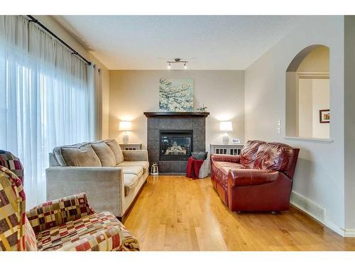 229 Cimarron Drive, Okotoks, AB - Indoor Photo Showing Living Room With Fireplace