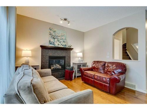 229 Cimarron Drive, Okotoks, AB - Indoor Photo Showing Living Room With Fireplace