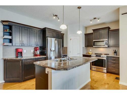 229 Cimarron Drive, Okotoks, AB - Indoor Photo Showing Kitchen With Stainless Steel Kitchen With Double Sink With Upgraded Kitchen