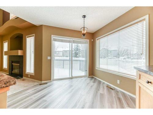 82 Tuscany Ravine Road Nw, Calgary, AB - Indoor Photo Showing Other Room With Fireplace