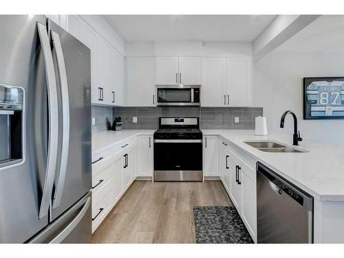 141 Crestridge Common Sw, Calgary, AB - Indoor Photo Showing Kitchen With Stainless Steel Kitchen With Double Sink