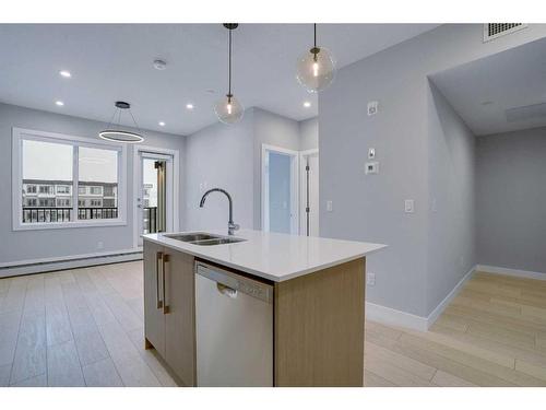 1318-111 Wolf Creek Drive Se, Calgary, AB - Indoor Photo Showing Kitchen With Double Sink With Upgraded Kitchen