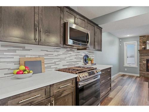 868 Lakewood Circle, Strathmore, AB - Indoor Photo Showing Kitchen With Fireplace