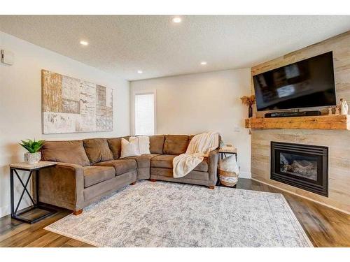 153 Arbour Wood Mews Nw, Calgary, AB - Indoor Photo Showing Living Room With Fireplace