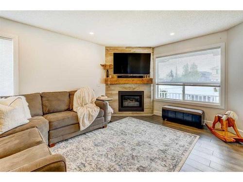 153 Arbour Wood Mews Nw, Calgary, AB - Indoor Photo Showing Living Room With Fireplace