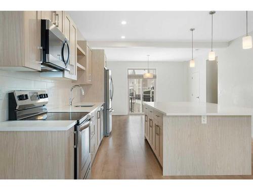 322 South Point Square Sw, Airdrie, AB - Indoor Photo Showing Kitchen With Upgraded Kitchen