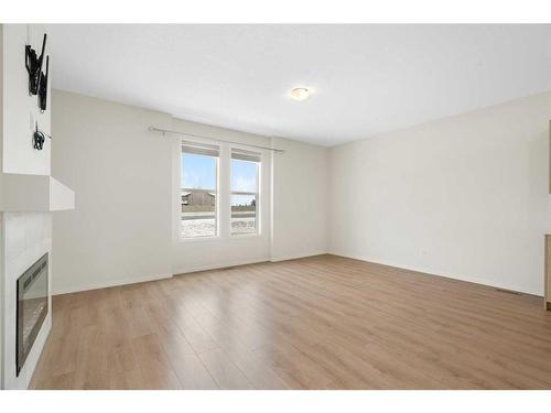 322 South Point Square Sw, Airdrie, AB - Indoor Photo Showing Other Room With Fireplace