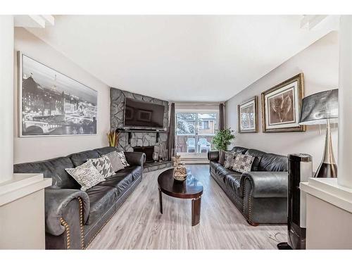 302-1001 68 Avenue Sw, Calgary, AB - Indoor Photo Showing Living Room With Fireplace