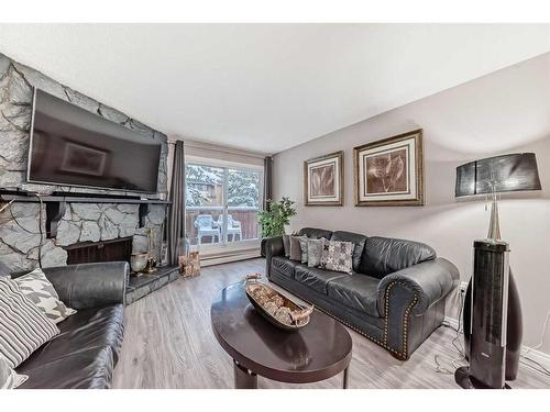 302-1001 68 Avenue Sw, Calgary, AB - Indoor Photo Showing Living Room With Fireplace