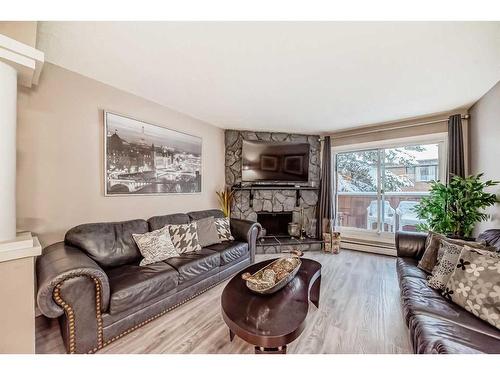 302-1001 68 Avenue Sw, Calgary, AB - Indoor Photo Showing Living Room With Fireplace