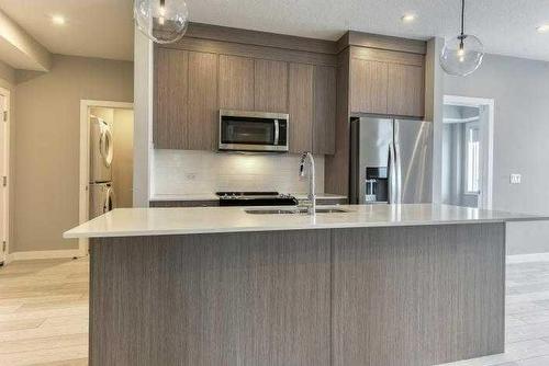 1409-111 Wolf Creek Drive Se, Calgary, AB - Indoor Photo Showing Kitchen With Upgraded Kitchen