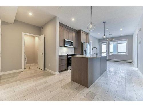 1409-111 Wolf Creek Drive Se, Calgary, AB - Indoor Photo Showing Kitchen With Upgraded Kitchen