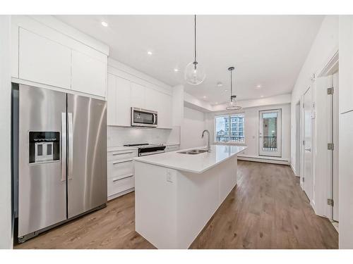 1201-111 Wolf Creek Drive Se, Calgary, AB - Indoor Photo Showing Kitchen With Stainless Steel Kitchen With Double Sink With Upgraded Kitchen