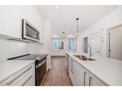 1201-111 Wolf Creek Drive Se, Calgary, AB - Indoor Photo Showing Kitchen With Double Sink With Upgraded Kitchen