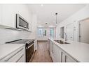 1201-111 Wolf Creek Drive Se, Calgary, AB  - Indoor Photo Showing Kitchen With Double Sink With Upgraded Kitchen 