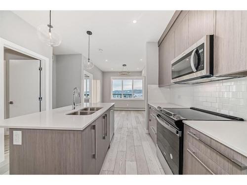 1515-111 Wolf Creek Drive Se, Calgary, AB - Indoor Photo Showing Kitchen With Double Sink With Upgraded Kitchen