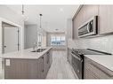 1515-111 Wolf Creek Drive Se, Calgary, AB  - Indoor Photo Showing Kitchen With Double Sink With Upgraded Kitchen 