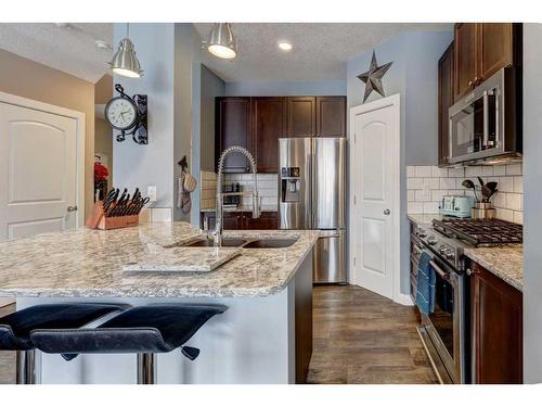 151 Ravenscroft Green Se, Airdrie, AB - Indoor Photo Showing Kitchen With Double Sink With Upgraded Kitchen