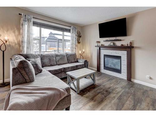 151 Ravenscroft Green Se, Airdrie, AB - Indoor Photo Showing Living Room With Fireplace