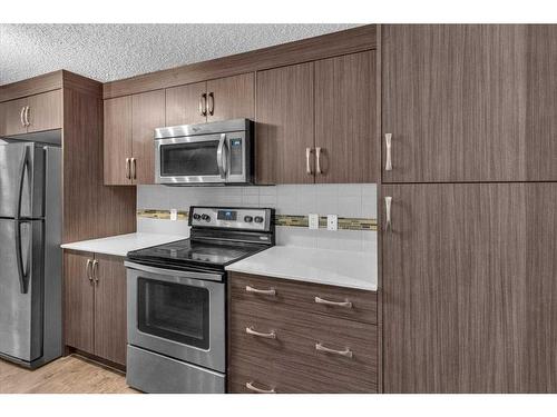 107 Auburn Bay Street Se, Calgary, AB - Indoor Photo Showing Kitchen With Stainless Steel Kitchen