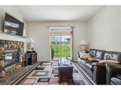 501-39 Hidden Creek Place Nw, Calgary, AB - Indoor Photo Showing Living Room With Fireplace