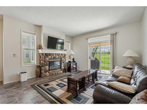 501-39 Hidden Creek Place Nw, Calgary, AB - Indoor Photo Showing Living Room With Fireplace