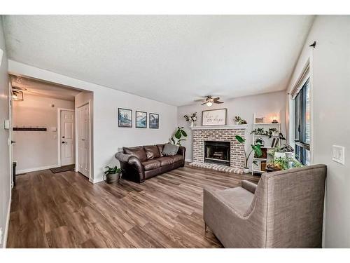 228 Riverglen Drive Se, Calgary, AB - Indoor Photo Showing Living Room With Fireplace