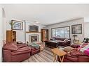 13 Bow Ridge Drive, Cochrane, AB  - Indoor Photo Showing Living Room With Fireplace 