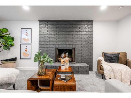 146 Winston Drive Sw, Calgary, AB - Indoor Photo Showing Living Room With Fireplace