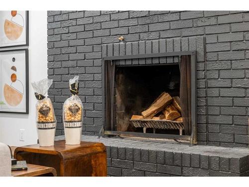 146 Winston Drive Sw, Calgary, AB - Indoor Photo Showing Living Room With Fireplace