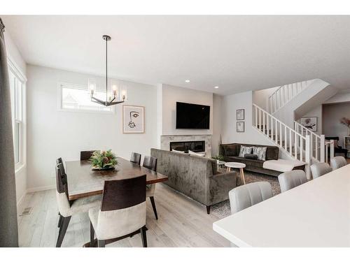 154 Cranbrook Cove, Calgary, AB - Indoor Photo Showing Dining Room With Fireplace