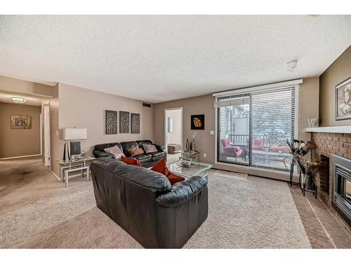 217-2425 90 Avenue Sw, Calgary, AB - Indoor Photo Showing Living Room With Fireplace