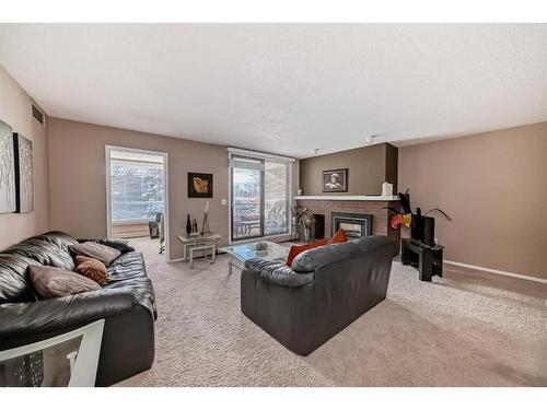 217-2425 90 Avenue Sw, Calgary, AB - Indoor Photo Showing Living Room With Fireplace