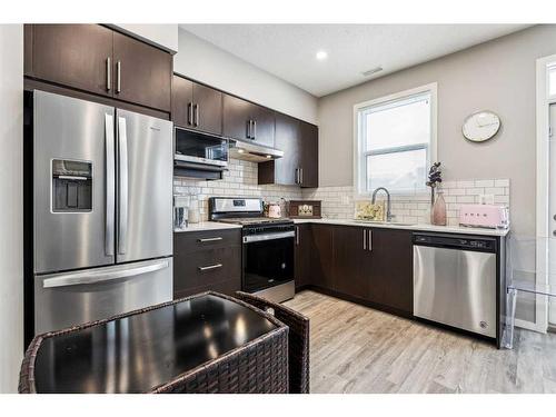 203-130 Redstone Walk Ne, Calgary, AB - Indoor Photo Showing Kitchen With Stainless Steel Kitchen With Double Sink With Upgraded Kitchen