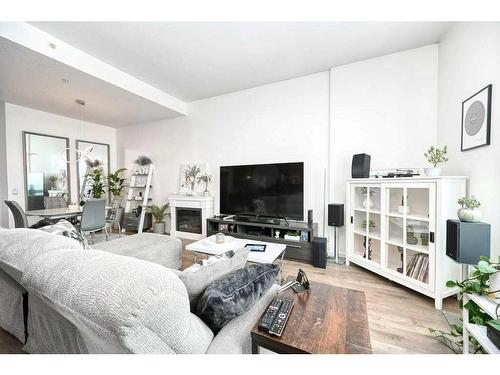 3305-210 15 Avenue Se, Calgary, AB - Indoor Photo Showing Living Room With Fireplace