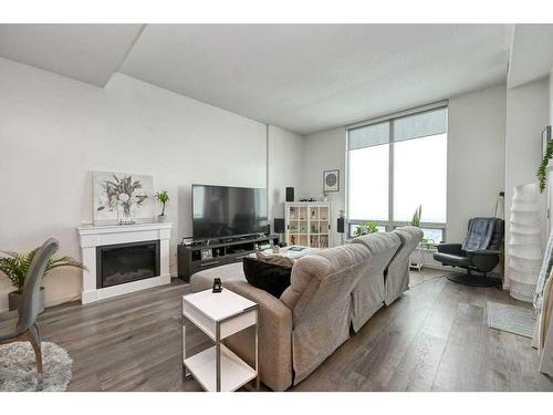 3305-210 15 Avenue Se, Calgary, AB - Indoor Photo Showing Living Room With Fireplace