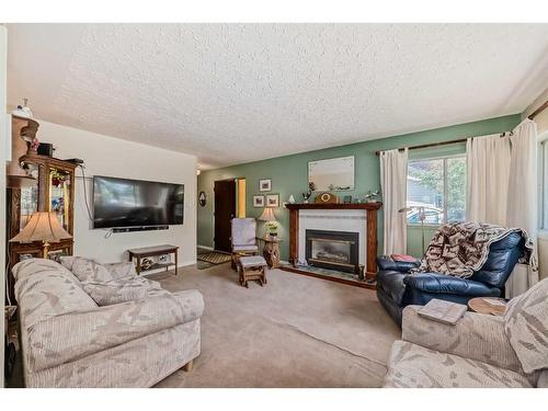 7611 Farrell Road Se, Calgary, AB - Indoor Photo Showing Living Room With Fireplace