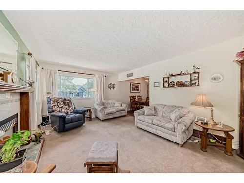 7611 Farrell Road Se, Calgary, AB - Indoor Photo Showing Living Room With Fireplace