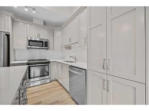 1005 Cranbrook Walk Se, Calgary, AB - Indoor Photo Showing Kitchen With Stainless Steel Kitchen With Upgraded Kitchen