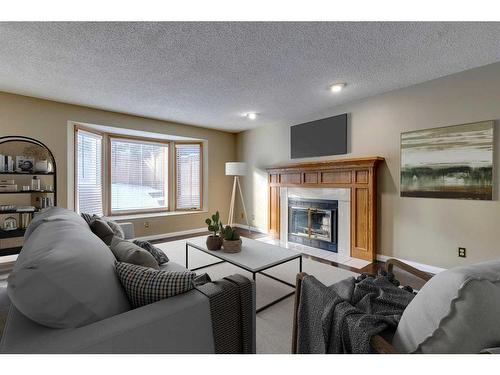 53 Shawnee Rise Sw, Calgary, AB - Indoor Photo Showing Living Room With Fireplace